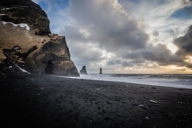 Dark sandy beach with ominous clouds