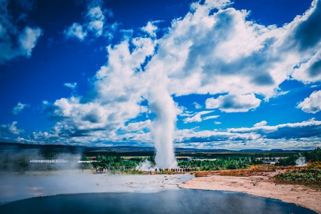 A geyer erupting  over 50 feet into the air in Thingvellir National Park